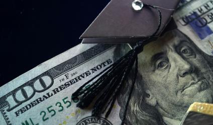 [image of $100 bill with small graduation cap placed above Benjamin Franklin's head]