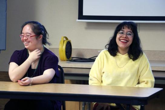 LifeLink students Alena Kennedy and Eliazbeth Zuniga laugh as their instructors point out that none of the student panelists said they enjoyed doing laundry or cleaning the bathroom at the R-Pad, where they learn various independent life skills.